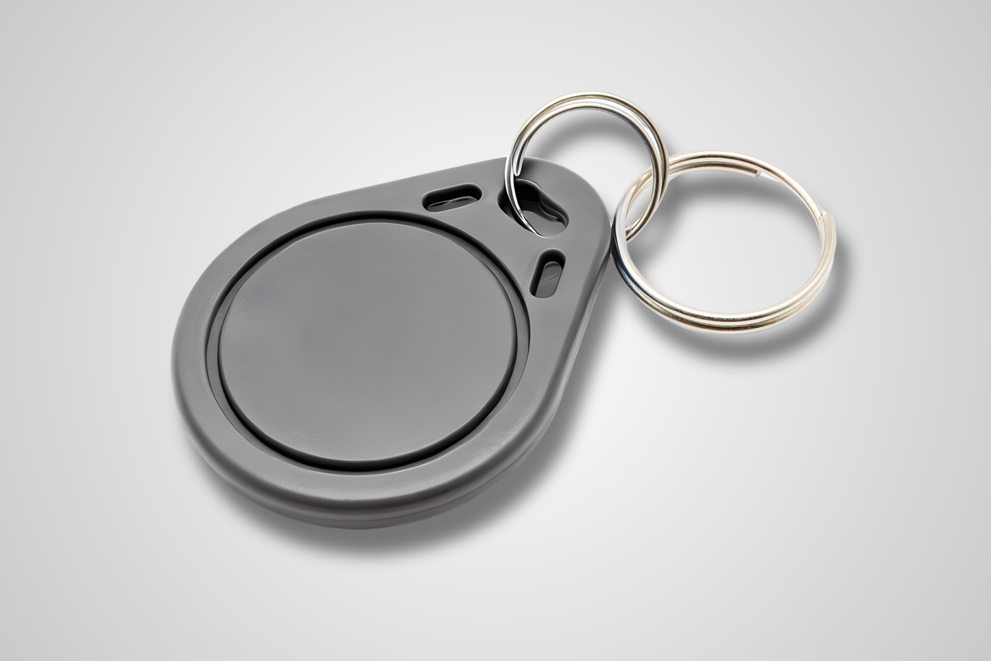 JM Band® NFC atslēgu piekariņa fotoattēls. Iegādājieties RFID pelēkā krāsā šeit.