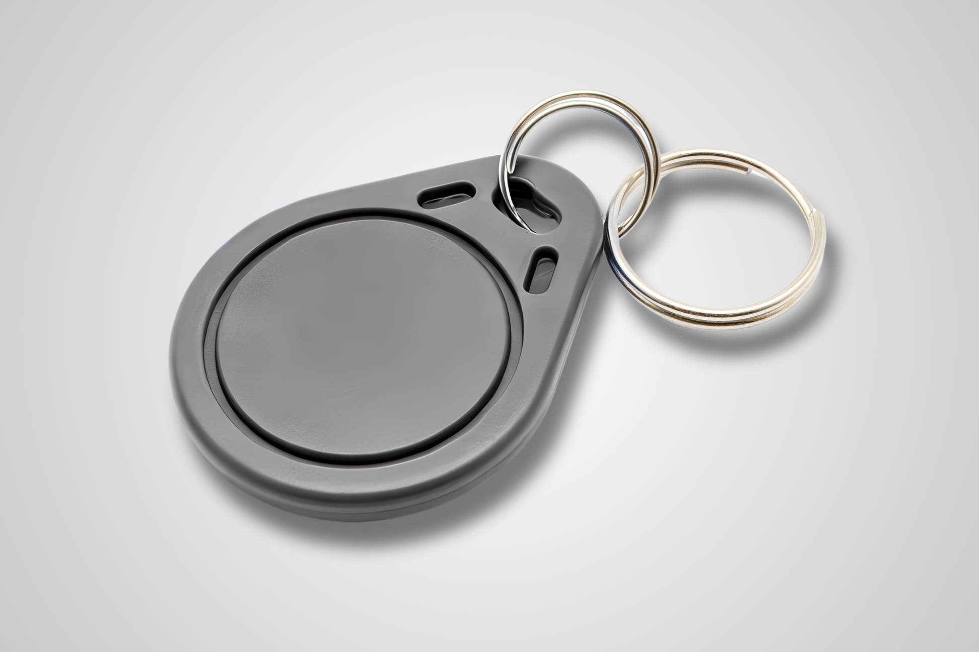 JM Band® NFC atslēgu piekariņa fotoattēls. Iegādājieties RFID pelēkā krāsā šeit.
