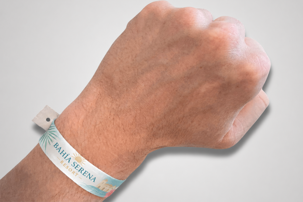 A printed fesitval wristband with snap closure on a wrist