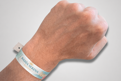 A printed fesitval wristband with snap closure on a wrist